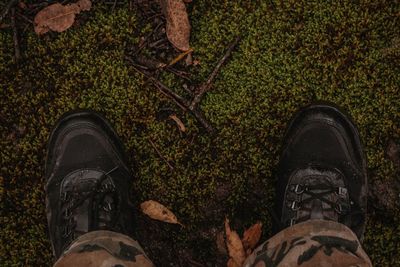 Low section of man standing on ground