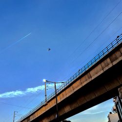 Low angle view of bridge against blue sky