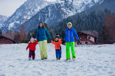 Rear view of woman skiing on snow covered mountain