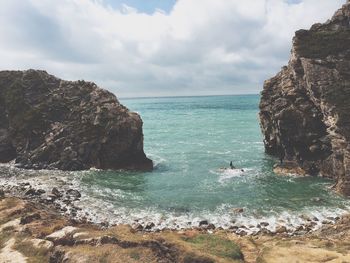 Scenic view of sea against cloudy sky