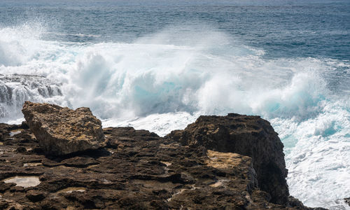 Waves splashing on rocks at shore