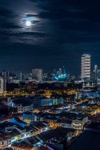 Illuminated cityscape against sky at night