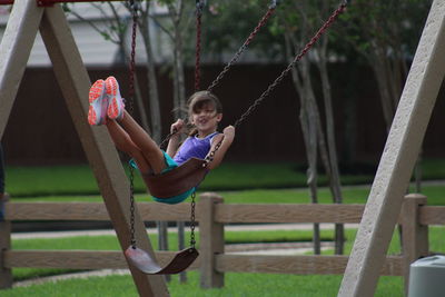 Girl enjoying swing at playground