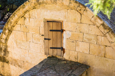 Open door on stone wall of building