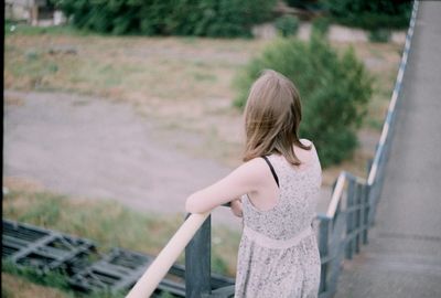High angle view of young woman standing on steps