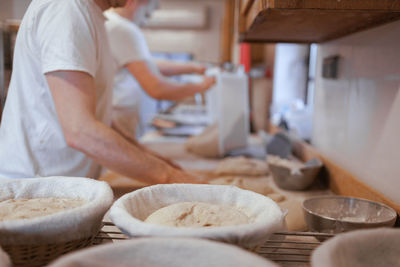 Midsection of man preparing bread