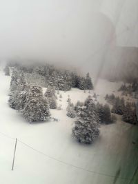 Scenic view of snow covered land against sky