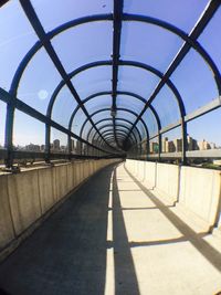 Bridge in city against clear sky