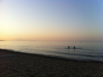 Silhouette of tourists on beach