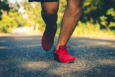 Low section of man running on road