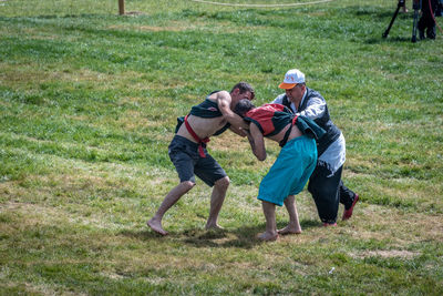 Rear view of people on field