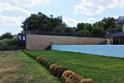 Built structure on field against sky