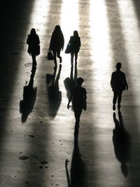 High angle view of silhouette people on floor