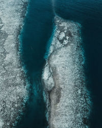 Aerial view of rock formation by sea