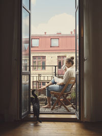 Woman reading book on balcony