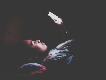 Low angle view of a man lying on bed at home