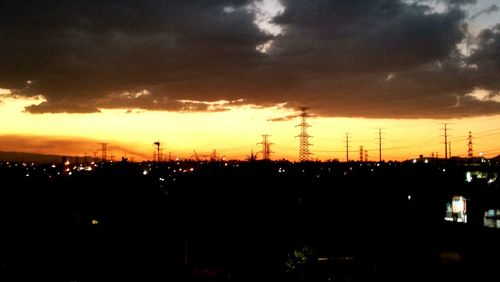 Silhouette city against sky during sunset