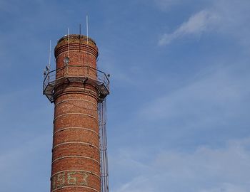 Low angle view of smoke stack against sky