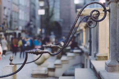 Close-up of metallic fence by road