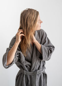 Womens health. spa and wellness. happy young woman applying hair mask in bathroom