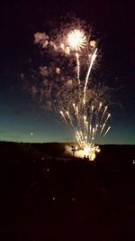 Low angle view of firework display at night