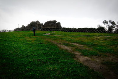 Man on field against sky