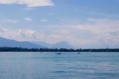 Sailboats in sea against sky