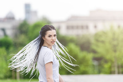 Portrait of young woman standing outdoors