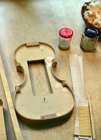 High angle view of incomplete guitar on table