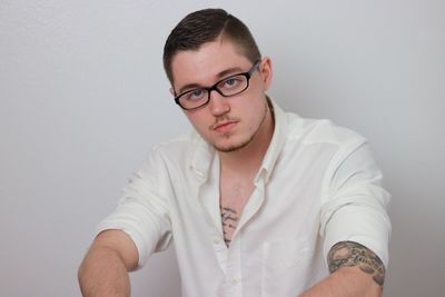 Portrait of young man against wall