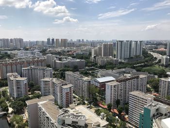 High angle view of modern buildings in city against sky