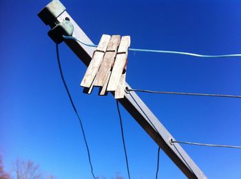 Low angle view of cables against blue sky