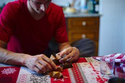 Midsection of man working on table