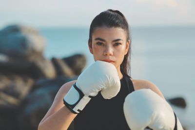 Portrait of young woman exercising at beach