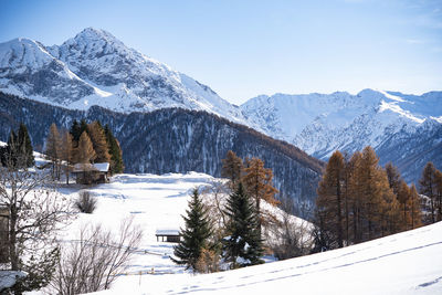 Scenic view of snow covered mountains against sky