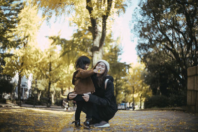 Couple kissing in park during autumn