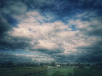 Scenic view of landscape against cloudy sky