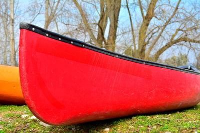 Close-up of red boat on land