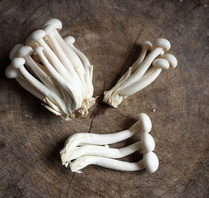 Top view  of fresh organic white beech mushrooms or shimeji mushrooms on a wooden chopping board