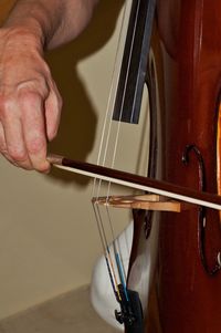 Midsection of man playing guitar