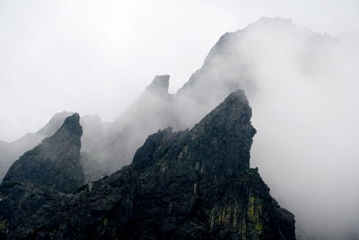 View of rock mountains amidst smoke