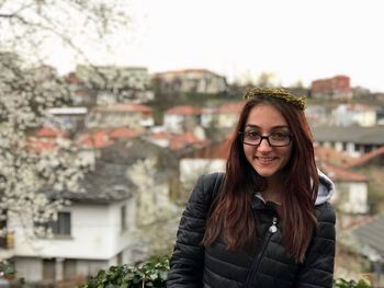 Young woman wearing jacket standing outdoors