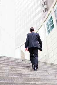 Rear view of man walking in city
