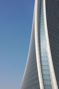 Low angle view of skyscraper against clear blue sky