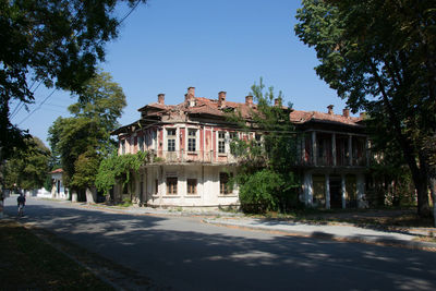 Building by road against sky