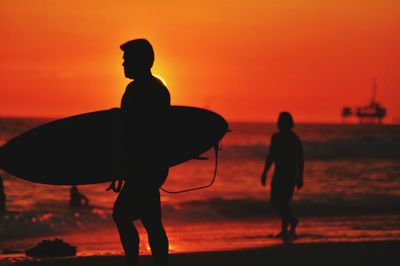 Silhouette of people at sunset