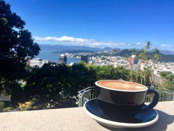 Close-up of coffee cup against sky