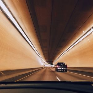 Road in tunnel seen through car windshield