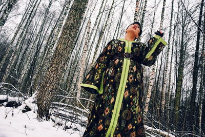 Woman standing on snow covered land