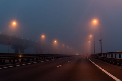 Empty road against sky at night